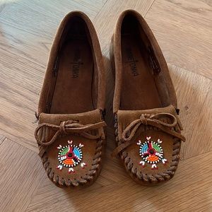 Brown Minnetonka loafers with detail of beads.